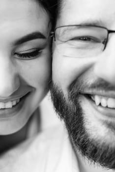 young couple in love a guy with a beard and a girl with dark hair in light clothes in the green forest