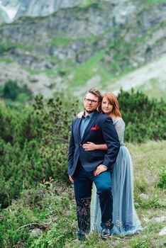 young couple on a walk near the lake surrounded by the Carpathian mountains