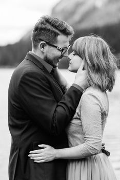 young couple on a walk near the lake surrounded by the Carpathian mountains