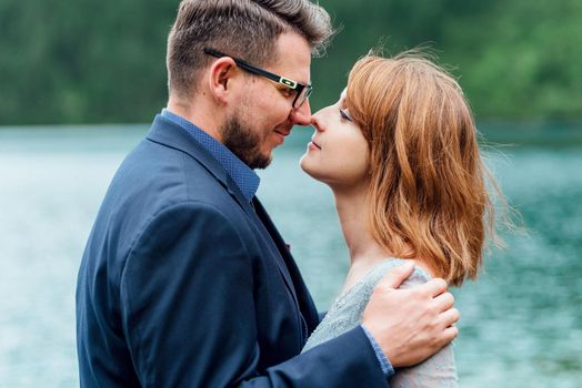 young couple on a walk near the lake surrounded by the Carpathian mountains