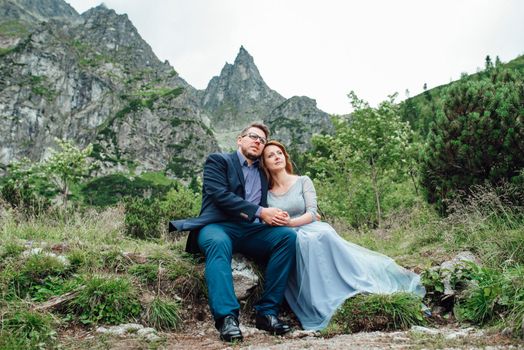 young couple on a walk near the lake surrounded by the Carpathian mountains