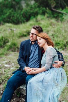 young couple on a walk near the lake surrounded by the Carpathian mountains