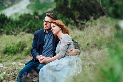 young couple on a walk near the lake surrounded by the Carpathian mountains