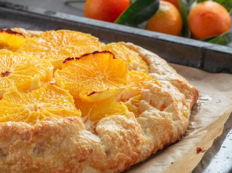 Close up view of caraway and orange tart in baking tray. Winter season and christmas ideas recipe - tart with caraway pastry and oranges, mandarines or tangerines.