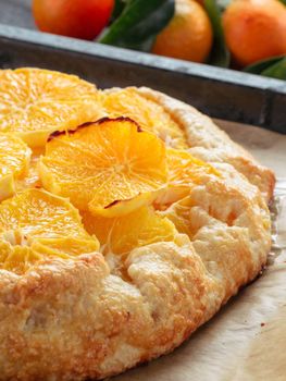 Close up view of caraway and orange tart in baking tray. Winter season and christmas ideas recipe - tart with caraway pastry and oranges, mandarines or tangerines.