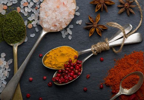 Various spices spoons on table. Top view with copy space