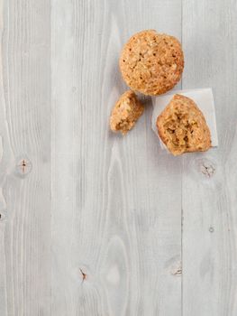 Top view of muffin with zucchini, carrots, apple and cinnamon on gray wooden background. Sweet vegetables homemade muffins. Toddler-friendly recipe idea. Copy space. Shallow DOF