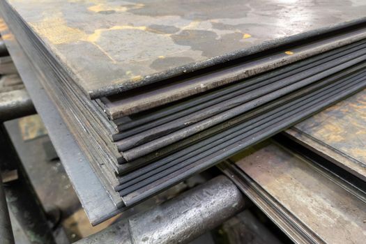 thick hot rolled steel sheets stack corner, close-up.