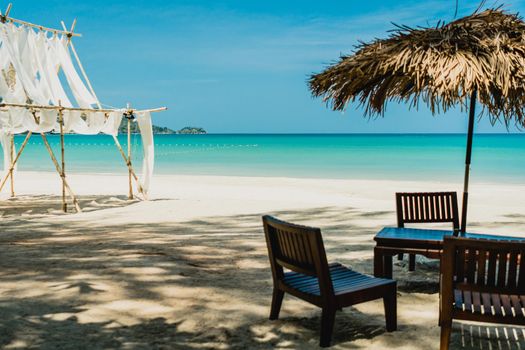 Table and chair at tropical summer beach background.