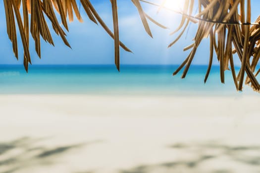 Tropical nature clean beach and white sand in summer season with sun light blue sky background.