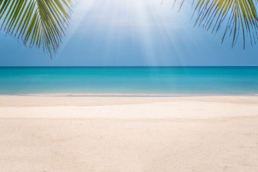 Tropical nature clean beach and white sand in summer season with sun light blue sky background.