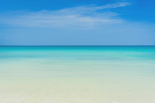 Tropical nature clean beach and white sand in summer season with sun light blue sky background.