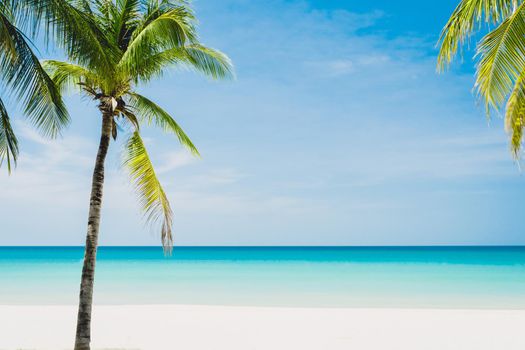 Tropical nature clean beach and white sand in summer season with sun light blue sky background.