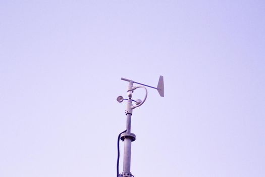 Weather station in silhouette over the sky at sunset. No people