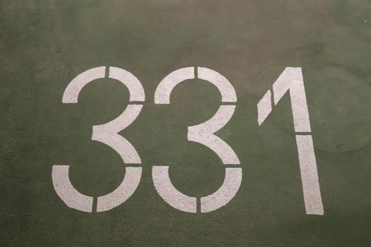 Numbers painted on concrete and asphalt textured surfaces