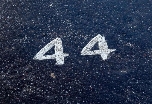 Numbers painted on concrete and asphalt textured surfaces