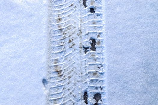 Tire Tracks on snow covered streets in a close up view