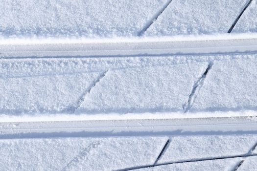 Tire Tracks on snow covered streets in a close up view