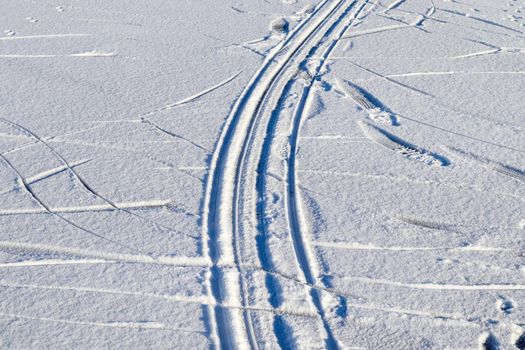 Tire Tracks on snow covered streets in a close up view