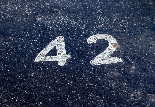 Numbers painted on concrete and asphalt textured surfaces