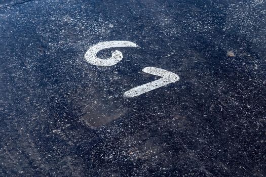 Numbers painted on concrete and asphalt textured surfaces