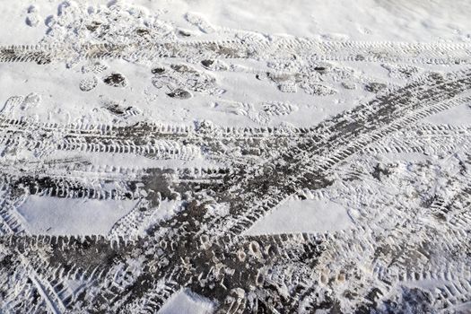 Tire Tracks on snow covered streets in a close up view