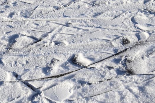 Tire Tracks on snow covered streets in a close up view