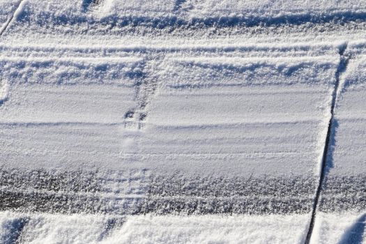 Tire Tracks on snow covered streets in a close up view