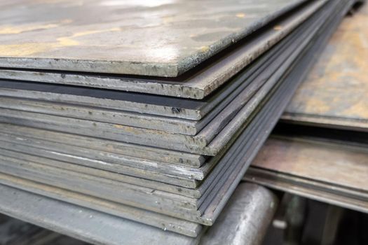 thick hot rolled steel sheets stack corner, close-up.