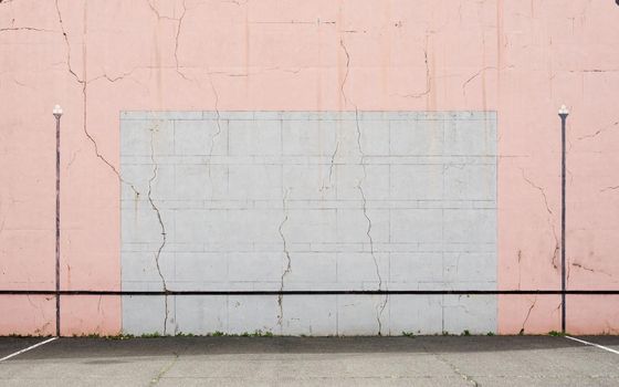 Cracked Basque pelota wall, pink and grey colours.