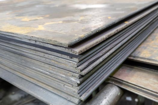 thick hot rolled steel sheets stack corner, close-up.