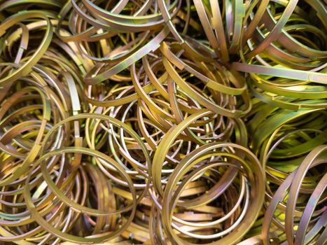 cadmium with chromatization yellow protective coating on steel ring parts pile - full frame close-up background with selectivef focus and blur