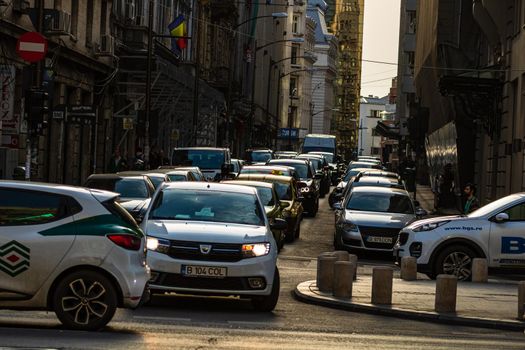 Car traffic at rush hour in downtown area of the city. Car pollution, traffic jam in the morning and evening in the capital city of Bucharest, Romania, 2020