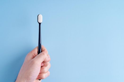 Fashionable toothbrush with soft bristles. Popular toothbrush. Hygiene trends.