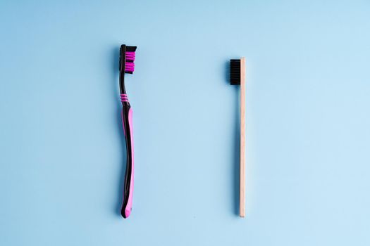 Making choice between plastic toothbrush and eco-friendly bamboo toothbrush. Worldwide Eco trends.
