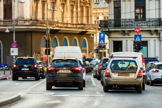 Car traffic at rush hour in downtown area of the city. Car pollution, traffic jam in the morning and evening in the capital city of Bucharest, Romania, 2021