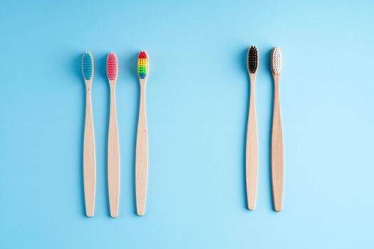 A bunch of eco-friendly bamboo toothbrushes. Global environmental trends. Gender and racial inequality. toothbrushes of different genders.