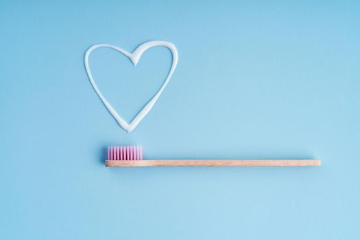 Eco-friendly trendy bamboo toothbrush. Popular toothbrushes. Hygiene trends. Top view with toothpaste.