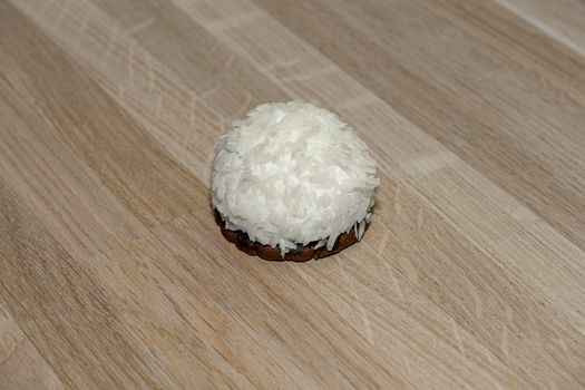 marshmallows in coconut shavings on a wooden background. High quality photo