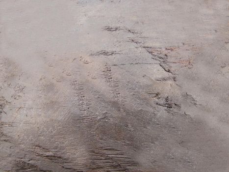 The wet surface of the stone with irregularities and depressions on the surface is brown.Texture or background