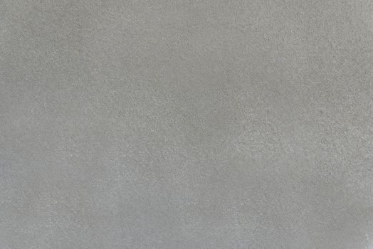 Rough and rough concrete surface of a gray wall close-up.Texture or background