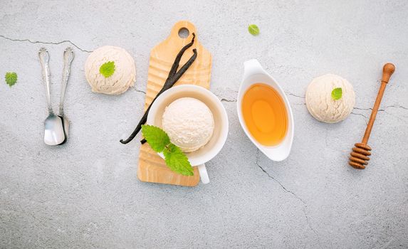 Vanilla ice cream flavor in bowl with vanilla pods setup on concrete background . Summer and Sweet menu concept.