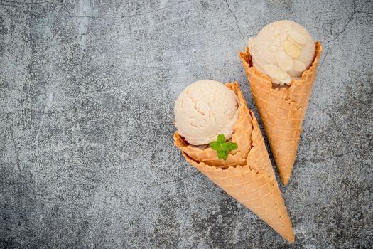 Vanilla ice cream flavor in cones setup on concrete background . Summer and Sweet menu concept.