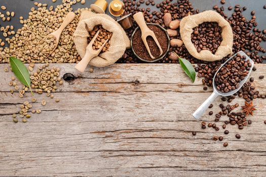 Background of various coffee , dark roasted coffee beans , ground and capsules with scoops setup on white concrete background with copy space.