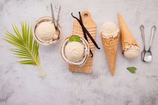 Coconut ice cream flavours in half of coconut setup on white stone background. Summer and Sweet menu concept.