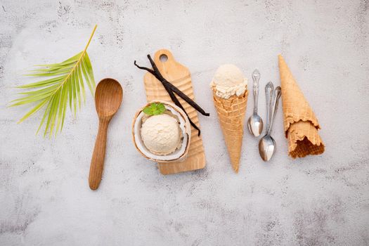 Coconut ice cream flavours in half of coconut setup on white stone background. Summer and Sweet menu concept.