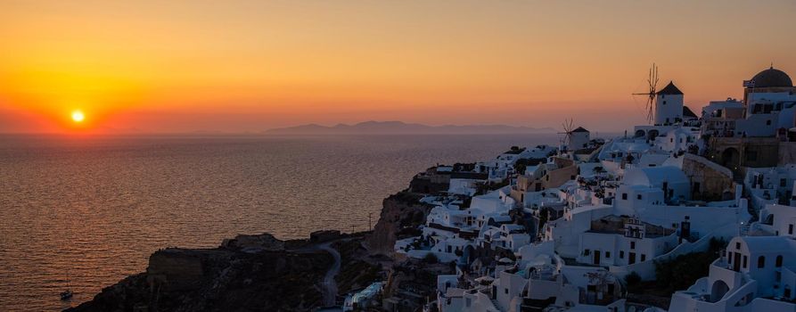 Oia village Santorini with blue domes and white washed house during sunset at the Island of Santorini Greece Europe, sunrise Santorini