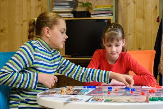 Two girls playing a board game