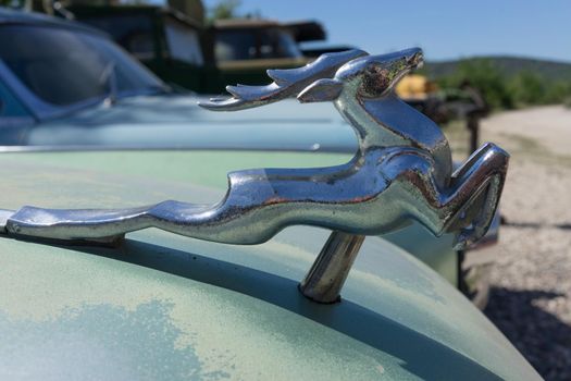 Sevastopol, Crimea-may 31, 2018: Background with a figure of a deer on the hood of an old car GAZ-21
