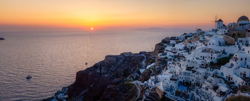 Oia village Santorini with blue domes and white washed house during sunset at the Island of Santorini Greece Europe, sunrise Santorini